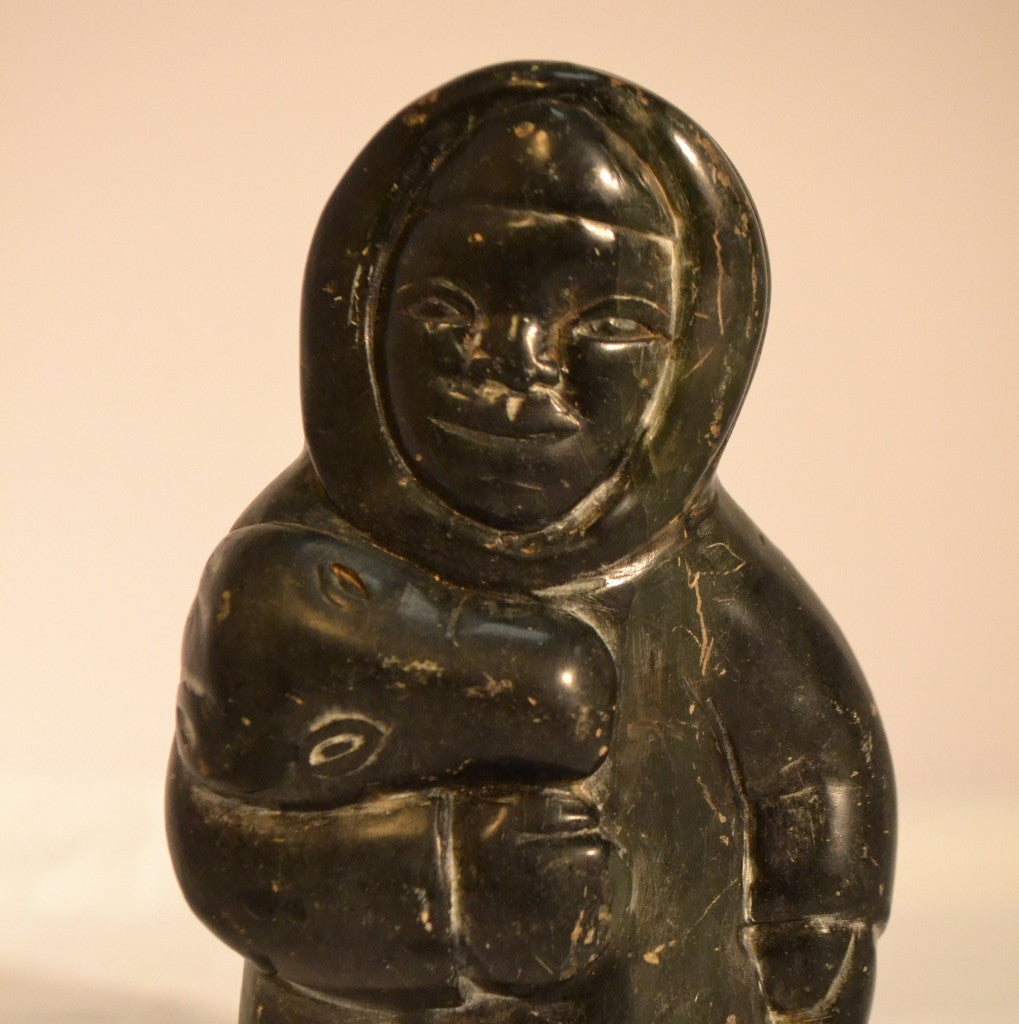 Hunter carrying bear head inuit carving