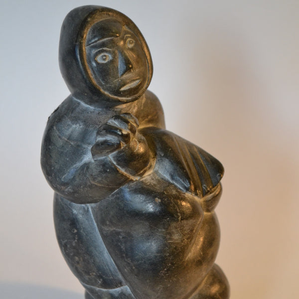 Inuit carving hunter carrying seal