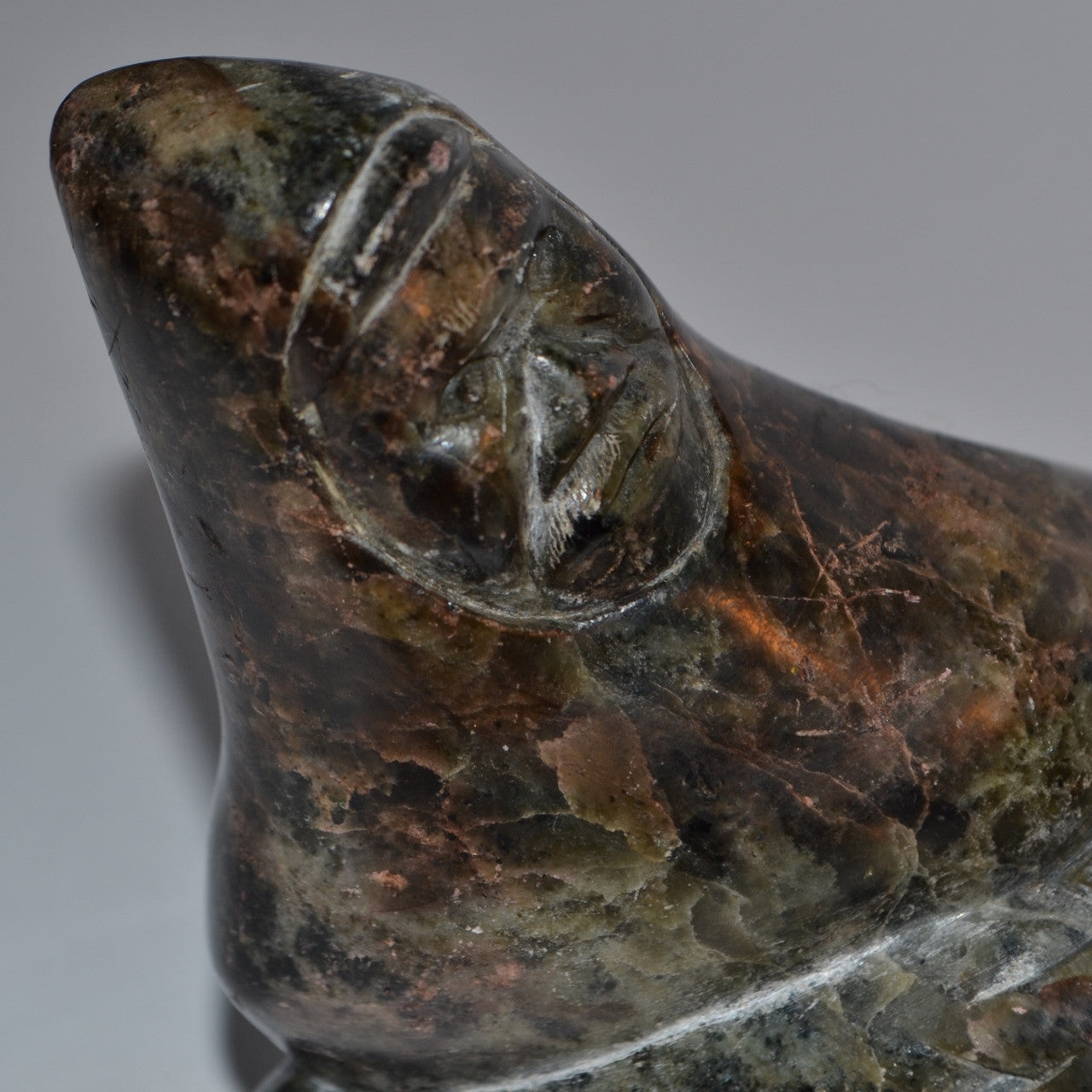 Inuit carving hunter wrestling seal