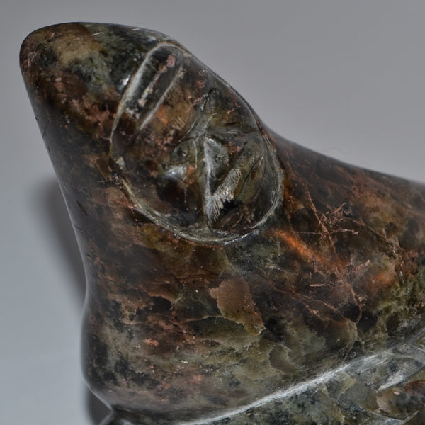 Inuit carving hunter wrestling seal