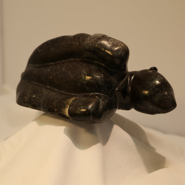 Polar bear playing with feet inuit carving