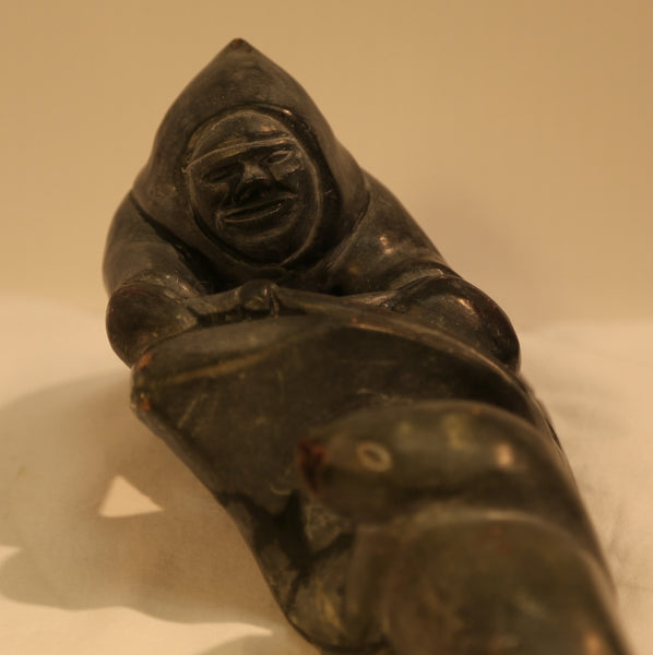 Hunter stalking seal carving