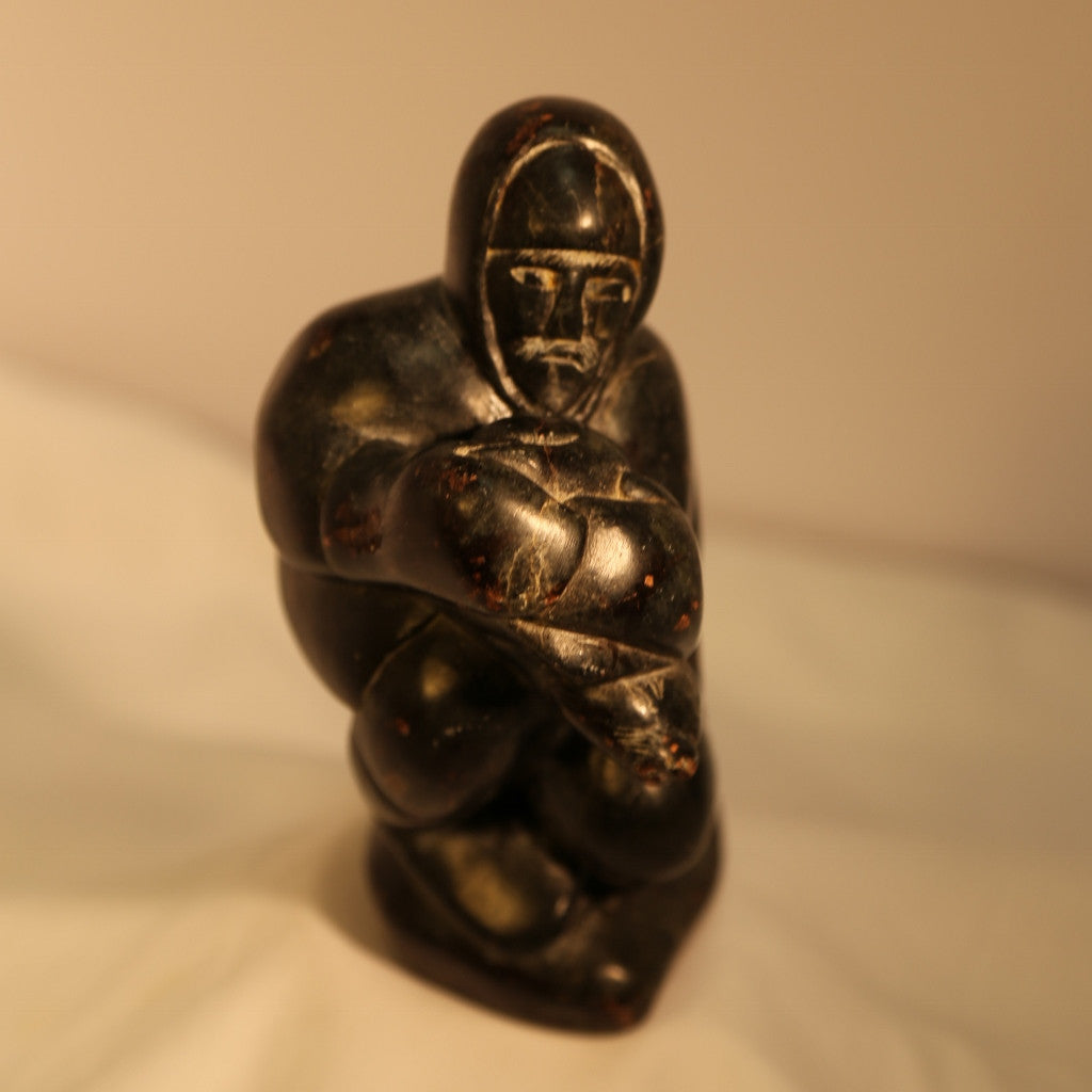 Hunter with seal head carving