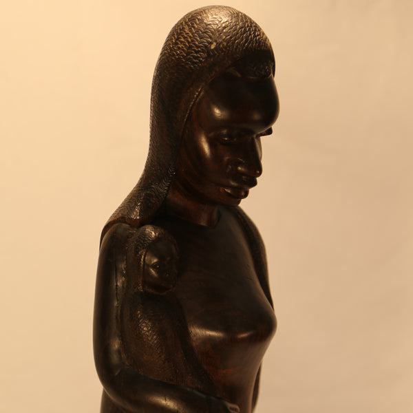 African mother with child wood carving faces