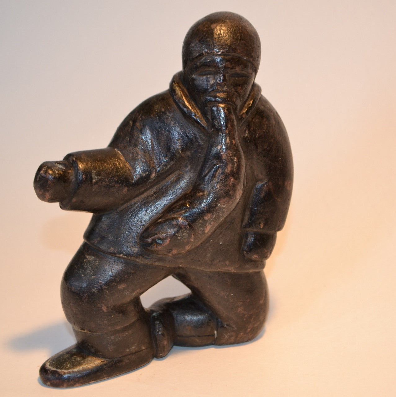 Inuit carving fisherman with fish in mouth