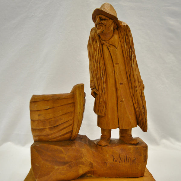 Fisherman with boat wood carving