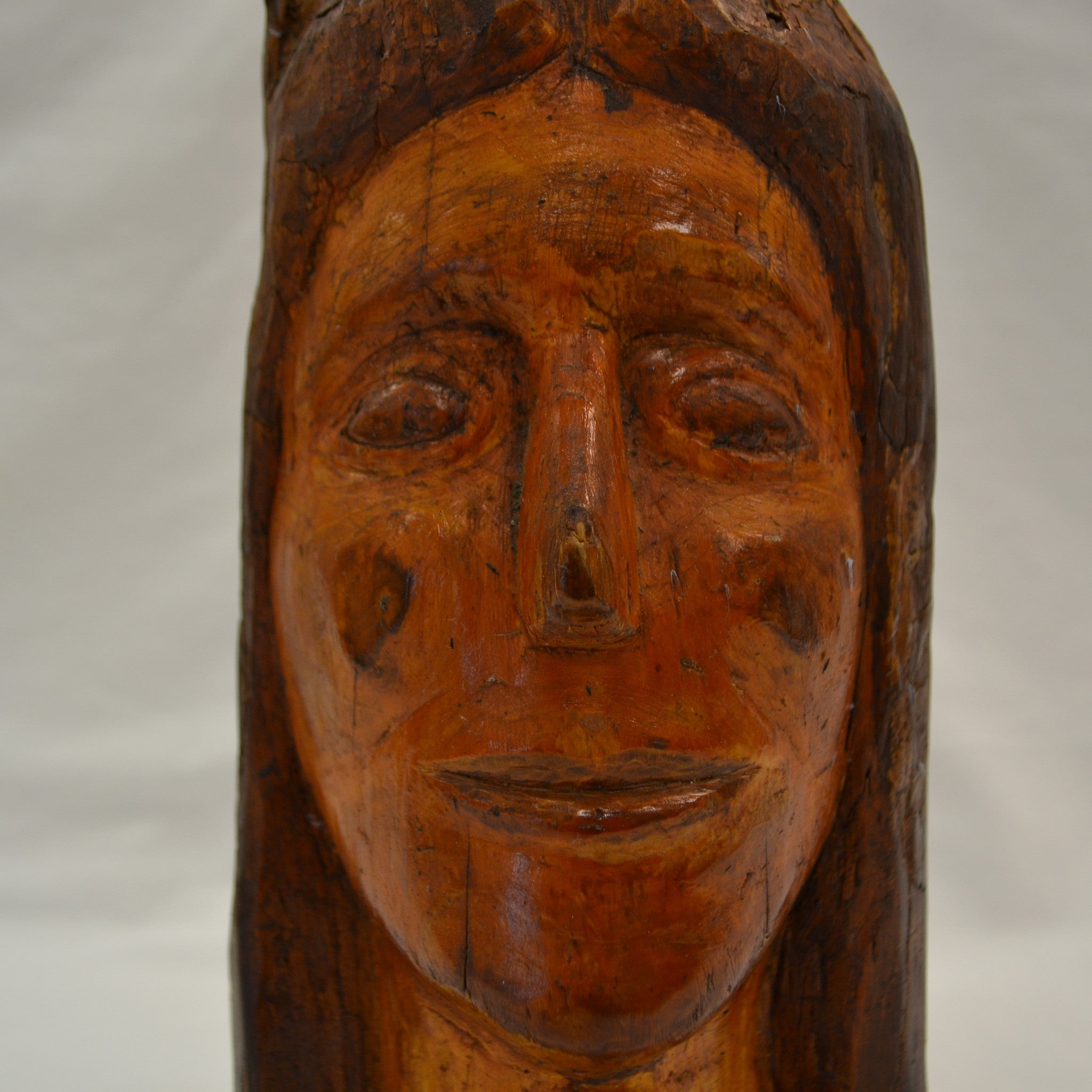 Indian face carved in branch folk art